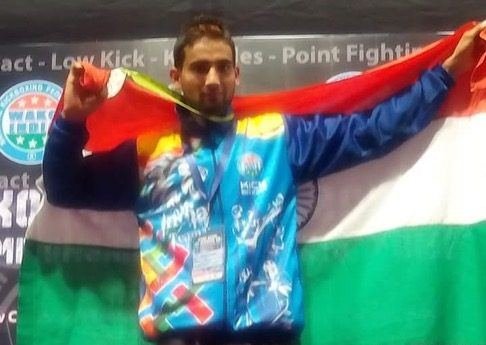 Pushpendra Veer Gurjar celebrating a championship medal with the Indian flag